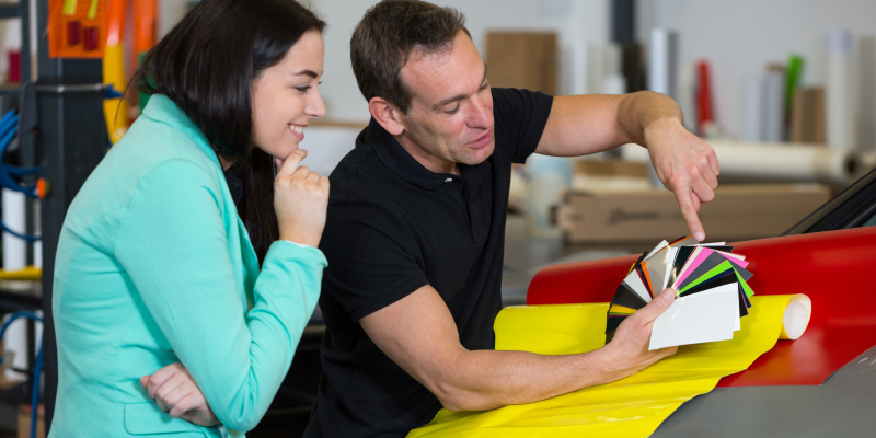 Car wrapping specialist consulting client about vinyl films
